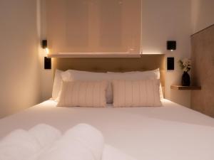 a bedroom with a large white bed with white pillows at Literal Hostel Madrid in Madrid +103 photos