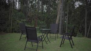 a group of chairs and a table in the grass at Ayana Gardens Ella in Ella