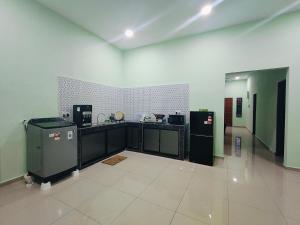 a kitchen with counters and appliances in a room at Seri Mersing Villa A in Mersing