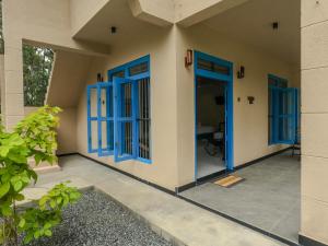 a house with blue doors and a patio at Ayana Gardens Ella in Ella