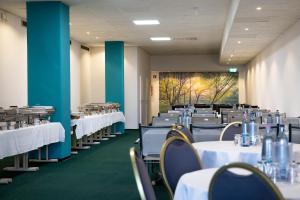 a dining room with white tables and chairs at Trip Inn Hotel Astoria in Göttingen