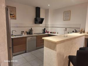 a kitchen with a sink and a counter top at Appartement confortable à Propriano avec balcon in Propriano