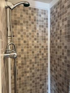 a shower with a shower head in a bathroom at The Clarendon Hotel in Blackpool +150 photos