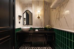 a bathroom with a sink and a mirror at C'Lau Hotel Ninh Binh - A Gem Nestled in Ancient Quarter in Ninh Binh +67 photos