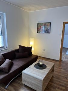 a living room with a couch and a coffee table at Bückeburg Living in Bückeburg +16 photos