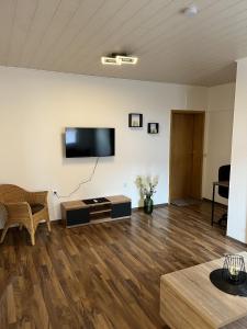 a living room with a flat screen tv on a wall at Bückeburg Living in Bückeburg