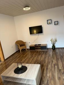 a living room with a flat screen tv on a wall at Bückeburg Living in Bückeburg