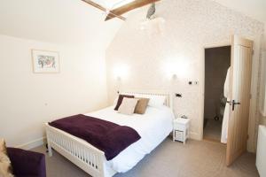 a bedroom with a large white bed in a room at The Bluebell in Helpston