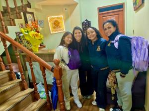 a group of women standing on the stairs at Hospedaje chakana inn in Cusco