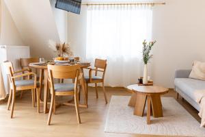 a living room with a table and chairs and a couch at Markowa Chata in Mizerna