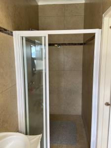 a shower with a glass door in a bathroom at Maerua Mall Units LUXE ACCOMMODATION in Windhoek +46 photos