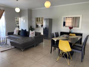 a living room with a couch and a table at Maerua Mall Units LUXE ACCOMMODATION in Windhoek