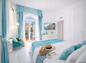 a hotel room with a bed with a hat on it at Villa Navarra in Praiano
