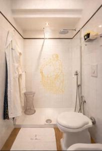 a bathroom with a toilet and a painting on the wall at Villa Navarra in Praiano +25 photos