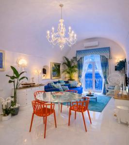 a living room with a table and chairs at Villa Navarra in Praiano