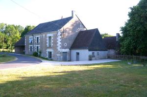 an old brick house with a road in front of it at Chambre du Grand Moulin in Saunay