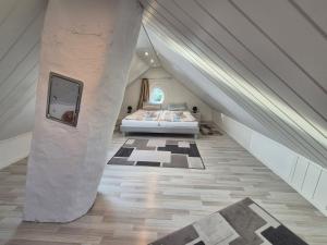 a attic bedroom with a bed and a staircase at Stadtvilla Norden in Norden