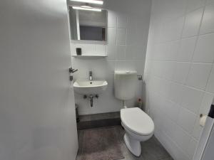a small bathroom with a toilet and a sink at Zauberhaus in Norddeich