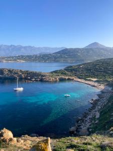 a large body of water with two boats in it at Dolce e Lumiu in Lumio