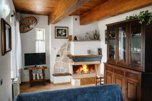 a living room with a fireplace and a blue couch at La Casa di Mary in Amelia