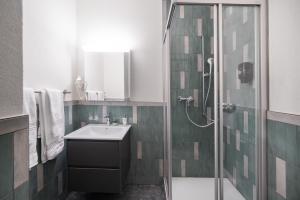 a bathroom with a sink and a shower at BetweenLakes Apartment ground fl in Interlaken +18 photos