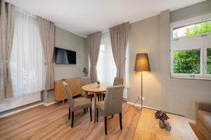 a living room with a table and chairs at BetweenLakes Apartment ground fl in Interlaken
