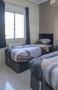 two beds in a bedroom with a window at Villa Veranos, Rojales, Benijofar, Alicante, Valencia in Rojales +68 photos