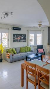 a living room with a couch and a table at Villa Veranos, Rojales, Benijofar, Alicante, Valencia in Rojales