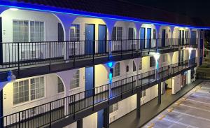 a building with blue lights on the side of it at Cloud 9 Inn LAX in Inglewood +38 photos