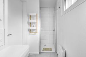 a white bathroom with a shower and a toilet at Haus Biederstaedt & LivJana in Ottersberg +34 photos
