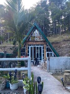 a small house with a roof with plants in front at Bilza A-House in Sagada +10 photos