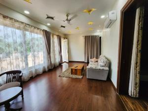 a living room with a couch and a table at The leaf and Hill in Alwar