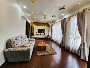 a living room with a couch and a table at The leaf and Hill in Alwar