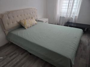 a bed in a bedroom with a pillow on it at 1 Apartments Angels okb in Altenburg