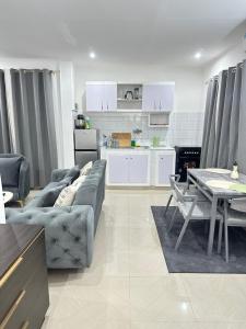 a living room with a couch and a table at Bungo Home - Suite Chambre & salon à 2 min de la plage in Pointe-Noire