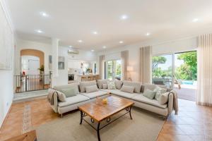 a living room with a couch and a table at Villa Mia - Vale do Lobo in Vale do Lobo