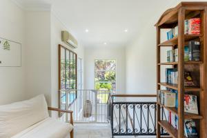 a living room with a book shelf at Villa Mia - Vale do Lobo in Vale do Lobo