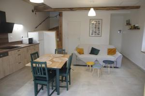 a kitchen and a dining room with a table and chairs at Appartement LE CHAI in Saint-Gaudens