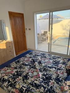 a bedroom with a bed with a view of the beach at Villa alnaser in Awlād ‘Umar +15 photos