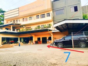 a car parked in a parking lot in front of a building at Zion Pension House in Ozamis