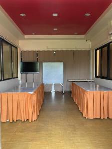 a conference room with two tables and a screen at Zion Pension House in Ozamis