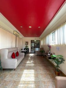 a living room with a red ceiling and a couch at Zion Pension House in Ozamis