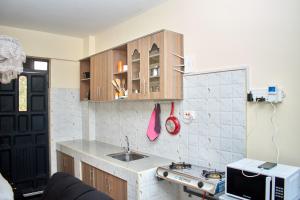 a small kitchen with a sink and a microwave at Deluxe Homes 2, Voi in Voi +10 photos