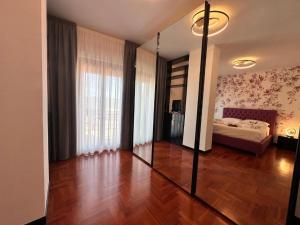 a room with a bedroom with a bed and a mirror at Appartamento Rosa in Gualdo Tadino +6 photos