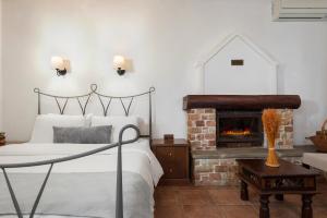 a bedroom with a bed and a fireplace at Archontiko Papoutsi Pelion in Mouresi