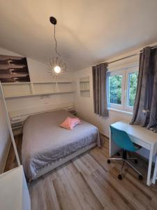 a bedroom with a bed and a desk and a window at Apartment Mia 2 in Rab