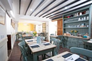 a restaurant with tables and chairs in a room at Bluebell Helpston in Helpston