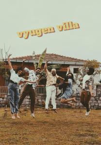 a group of people jumping in front of a wall at Vyugen Villa #01 in Kāraikkudi