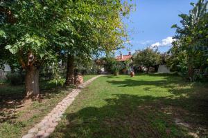 a garden with trees and a brick path at Esperado Gardens Maleme in Maleme