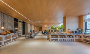 a restaurant with tables and chairs in a room at Intercity Hotel & Serviced Apartment Phnom Penh Downtown in Phnom Penh